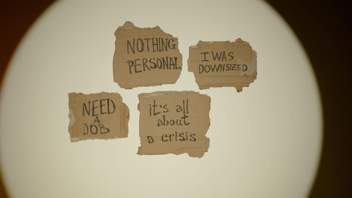 Cardboard signs convey job loss and economic crisis message, ideal for articles on unemployment.