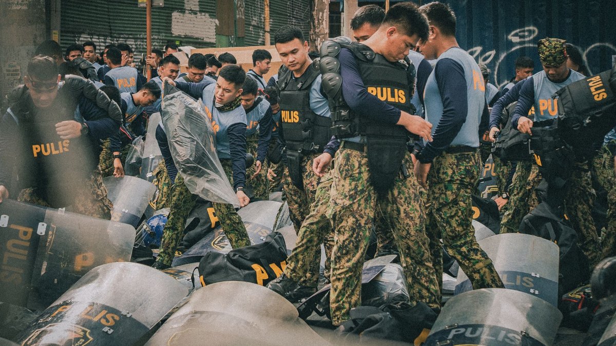 Philippine police officers in tactical gear prepare for a training exercise in Metro Manila.