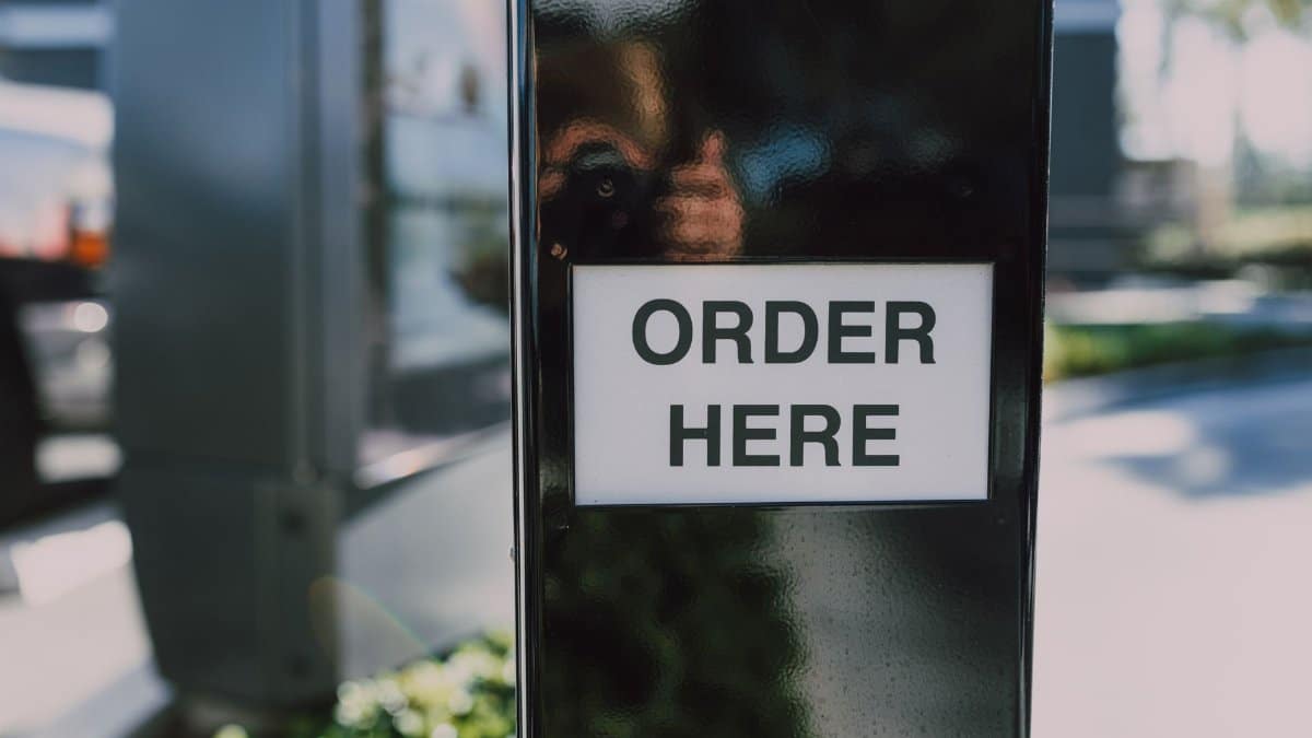 Close-up of an order sign at a drive-thru station, ideal for business contexts.