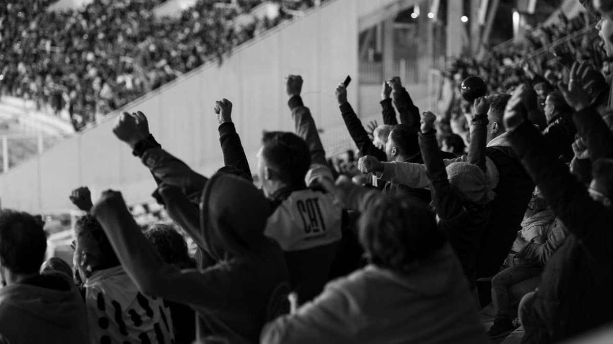 Vibrant crowd of football fans cheering in a Córdoba stadium, Argentina.