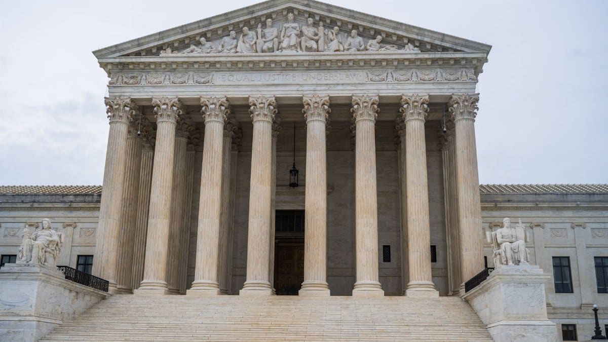 Front view of the iconic US Supreme Court building showcasing its grand columns and classic architecture.