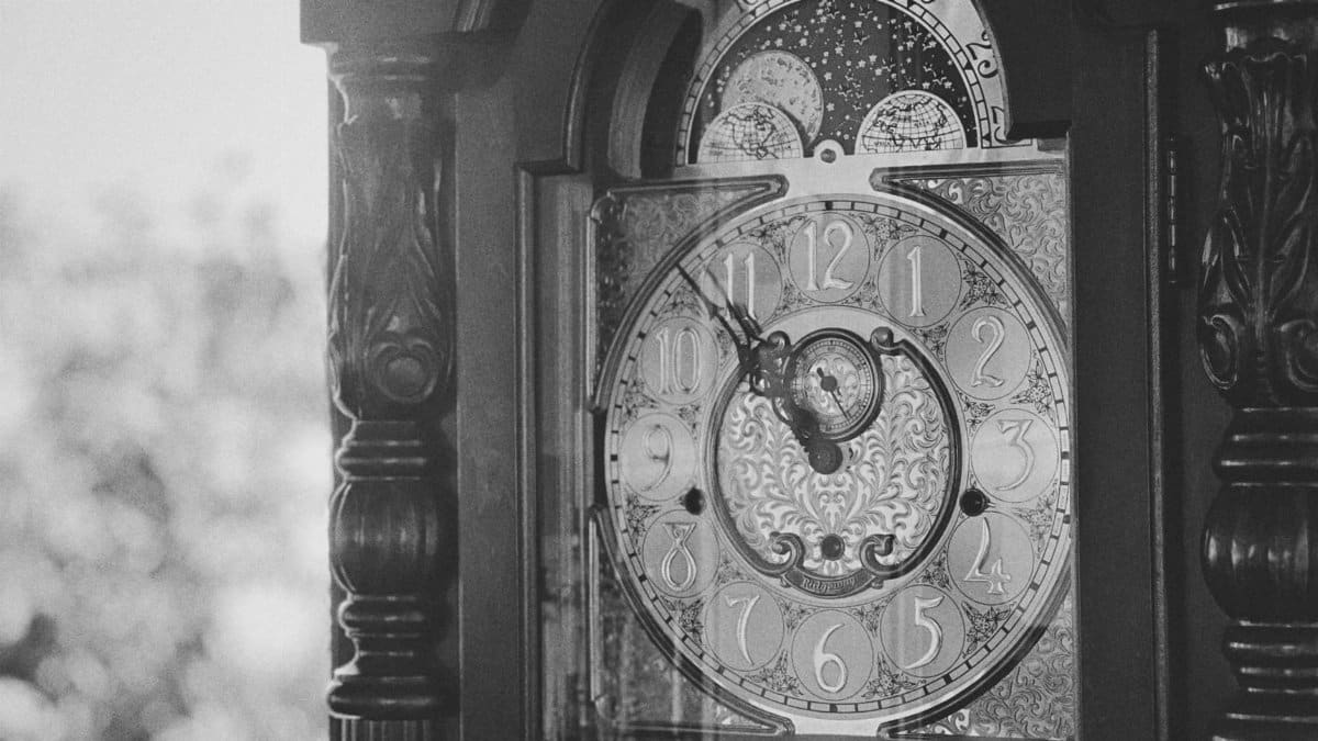 Detailed black and white image of a vintage grandfather clock face, captured in Bến Tre, Vietnam.