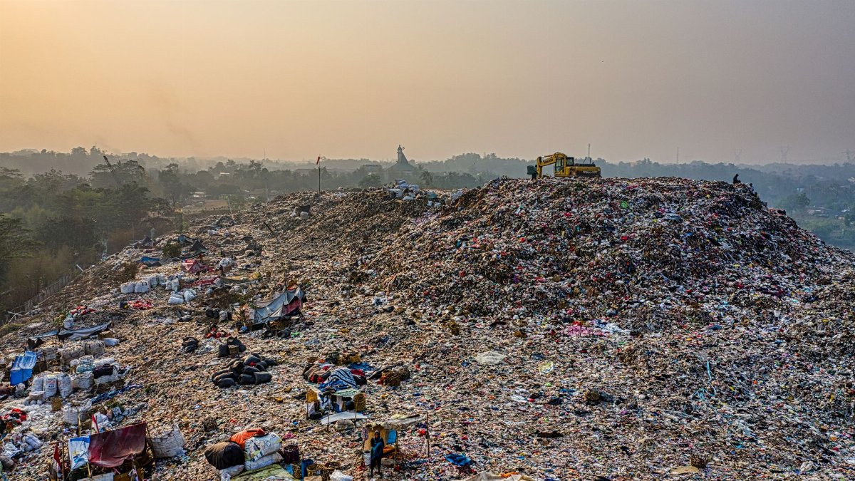 Aerial shot of a large landfill with garbage piles, showcasing waste management challenges.