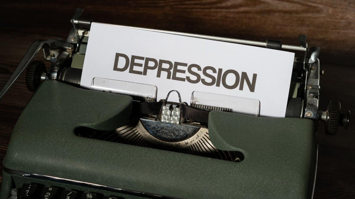 A vintage typewriter with the word 'Depression' typed on paper, conveying a mental health theme.