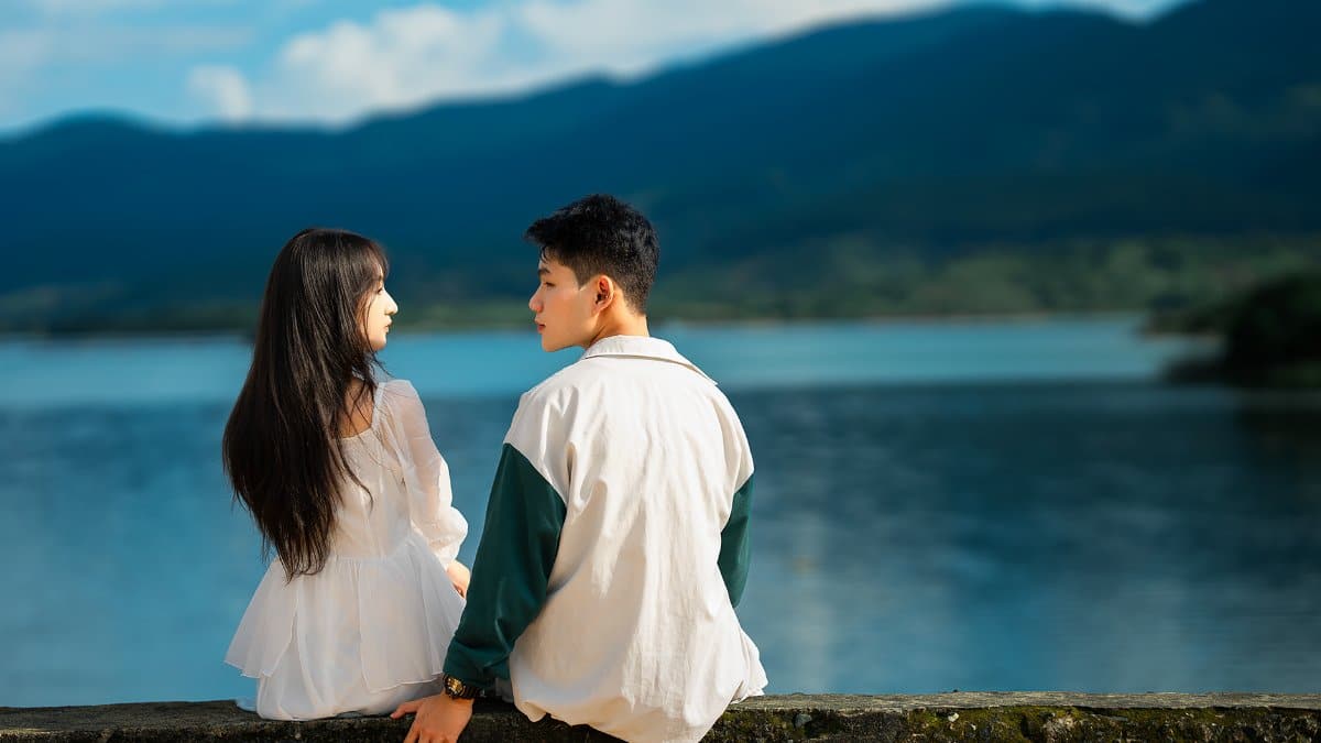 Young couple enjoying a peaceful moment by the lake in Dalat, Vietnam.