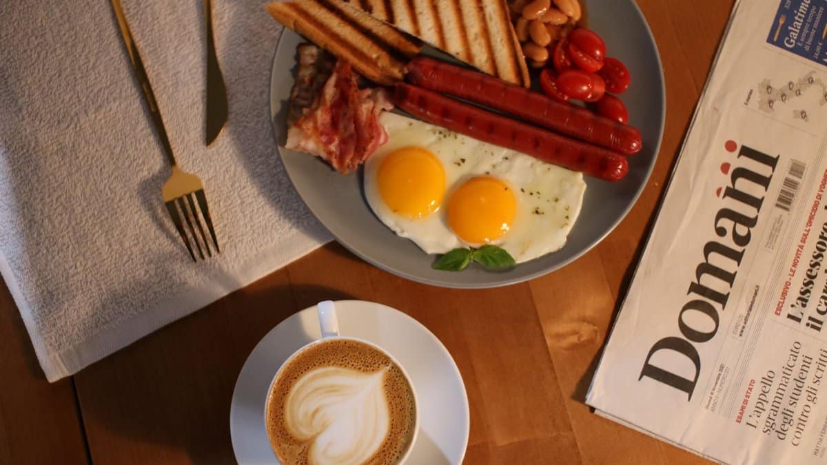 Flat lay of breakfast with eggs, coffee, and a newspaper offering a perfect morning vibe.