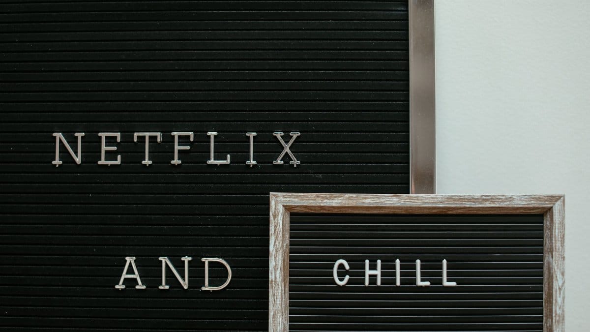 A letter board with the phrase 'Netflix and Chill' displayed in a minimalist style.
