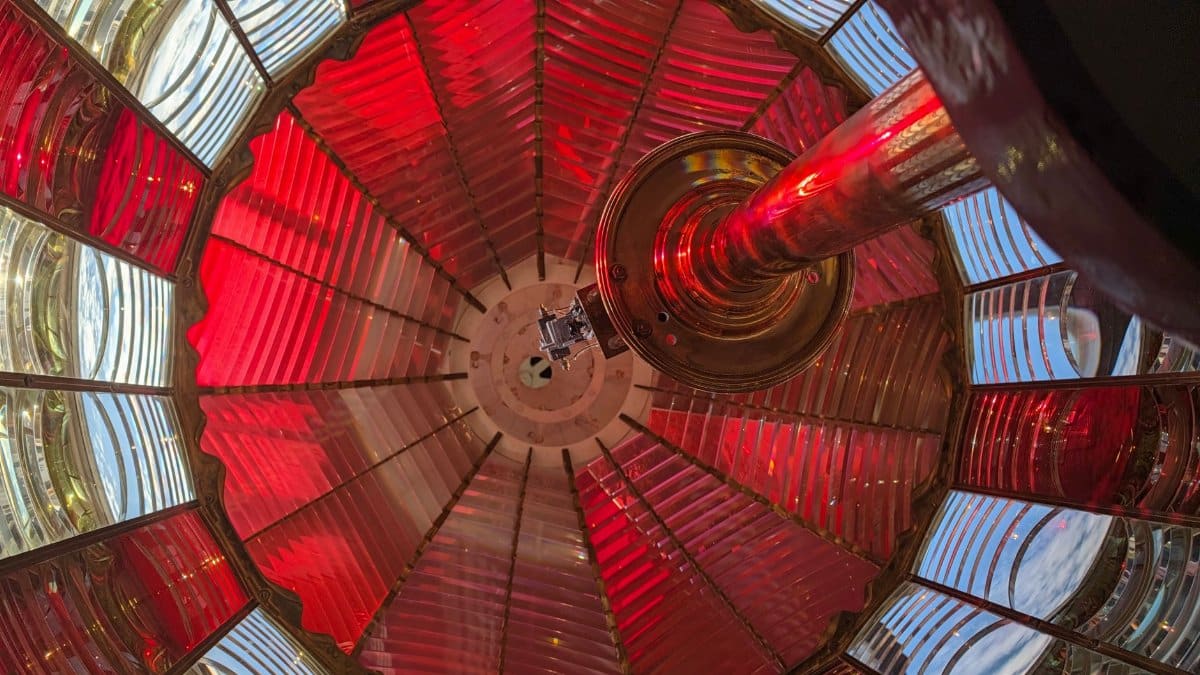 Stunning colorful view inside a lighthouse lens, showcasing red and clear glass panels.
