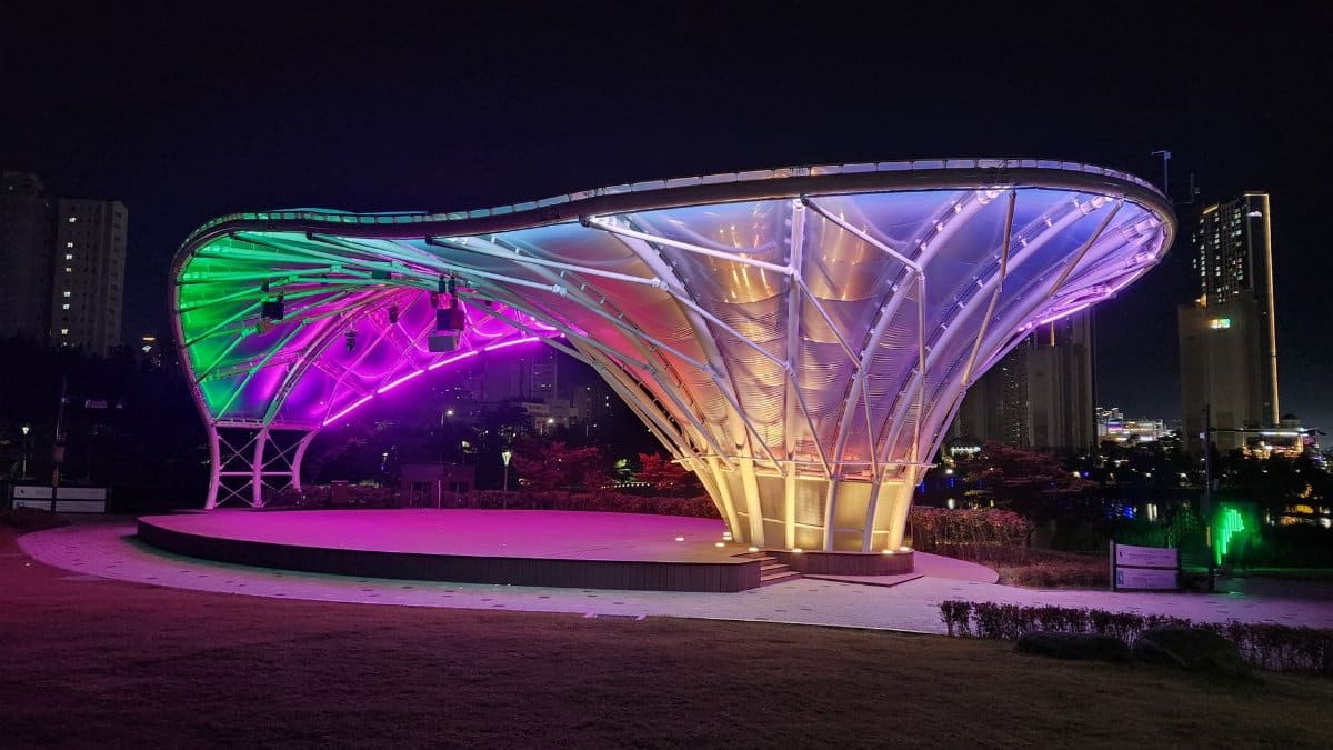 Vibrant night scene of a modern illuminated stage in Gimpo Lake Park, South Korea.