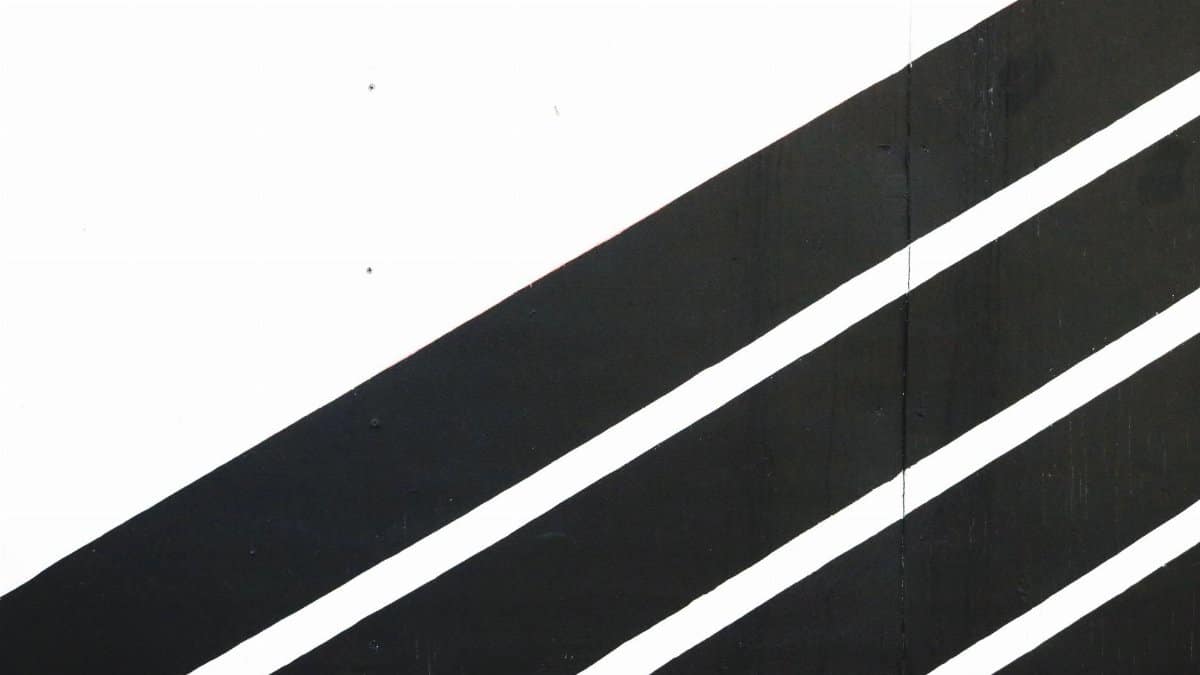 Dynamic black and white diagonal stripes create a modern contrast in this minimalist abstract art.