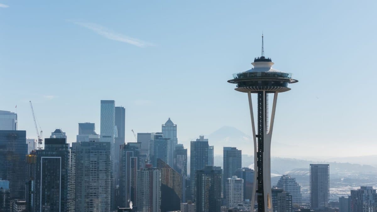 Iconic view of the Seattle skyline featuring the Space Needle and modern skyscrapers under a clear blue sky.