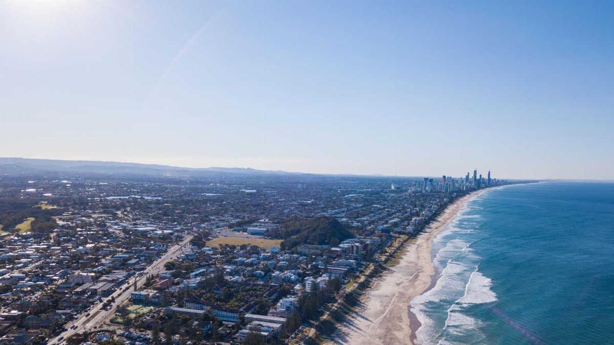 Stunning aerial view of Gold Coast, Queensland's coastline stretching along the ocean in daylight.