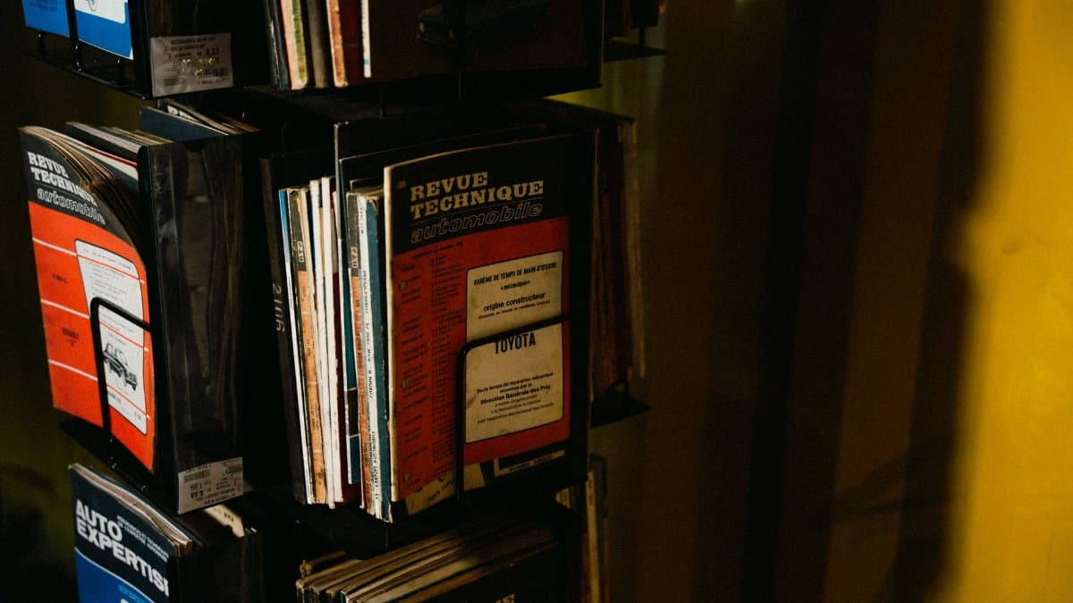 A collection of vintage car repair manuals on display, showcasing automotive history.