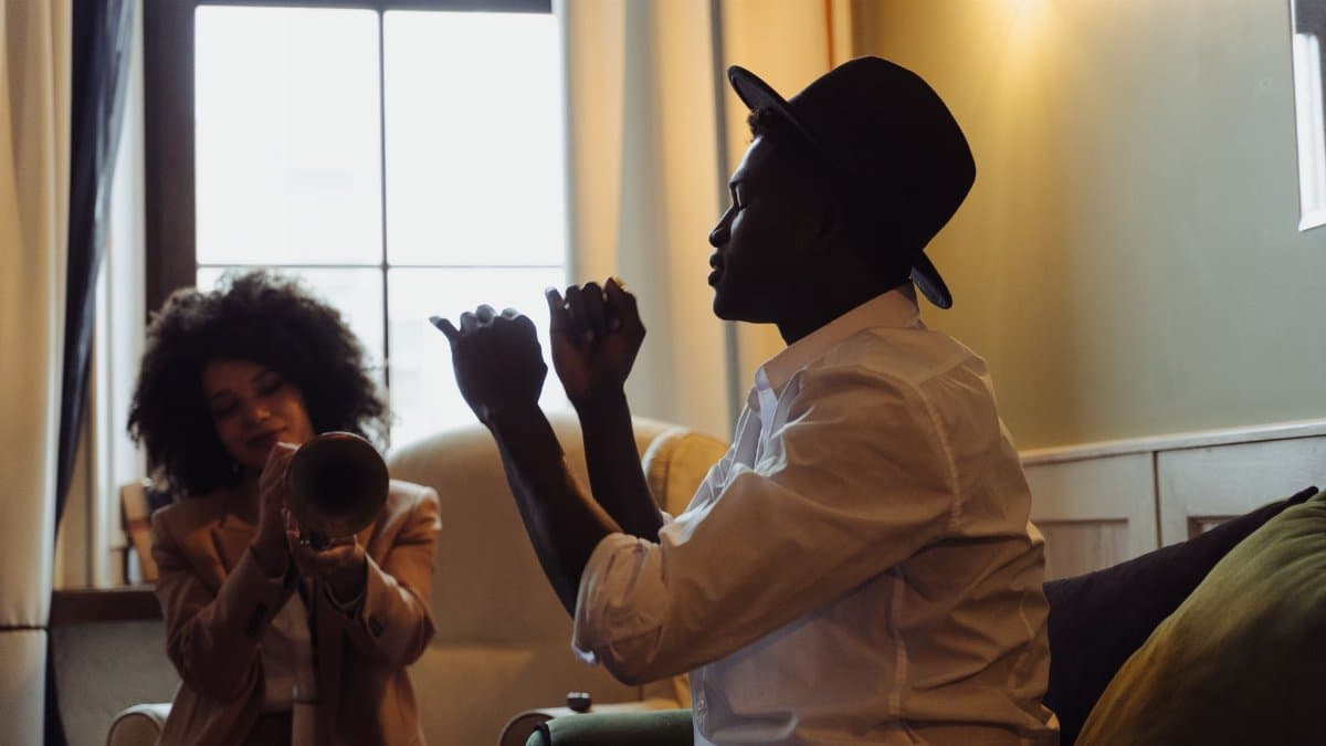 Two musicians jamming indoors, featuring a trumpet and dynamic interaction.