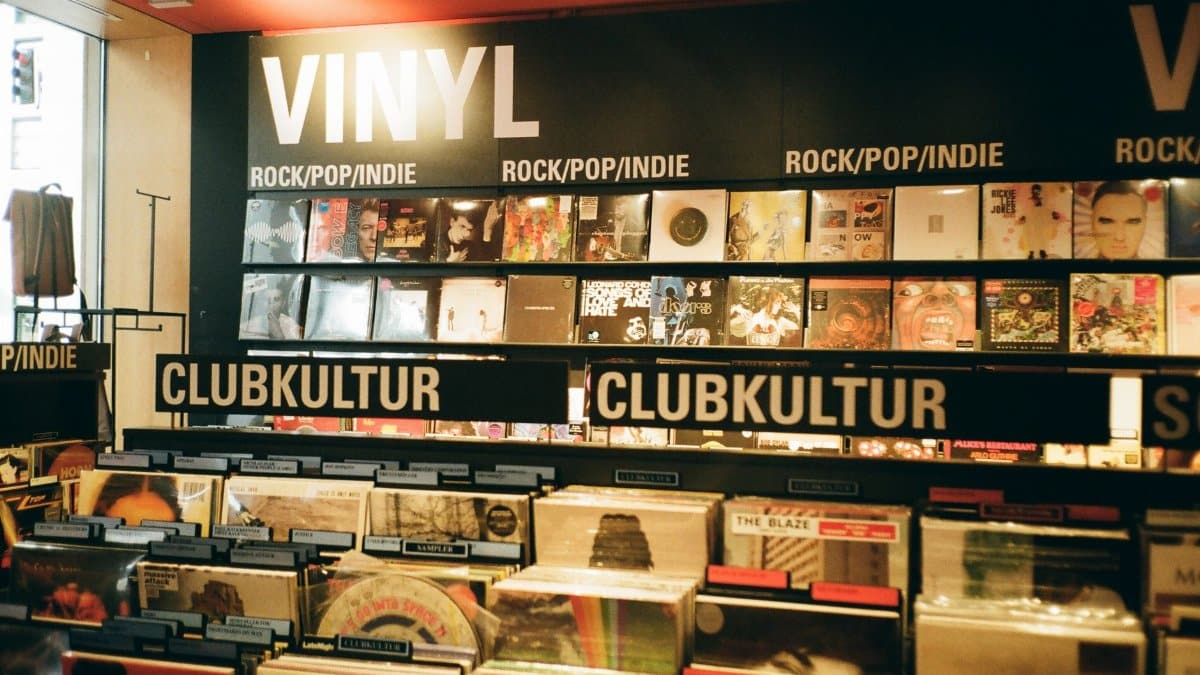 A vibrant indie music store displaying a variety of vinyl records under the categories rock, pop, and club culture.