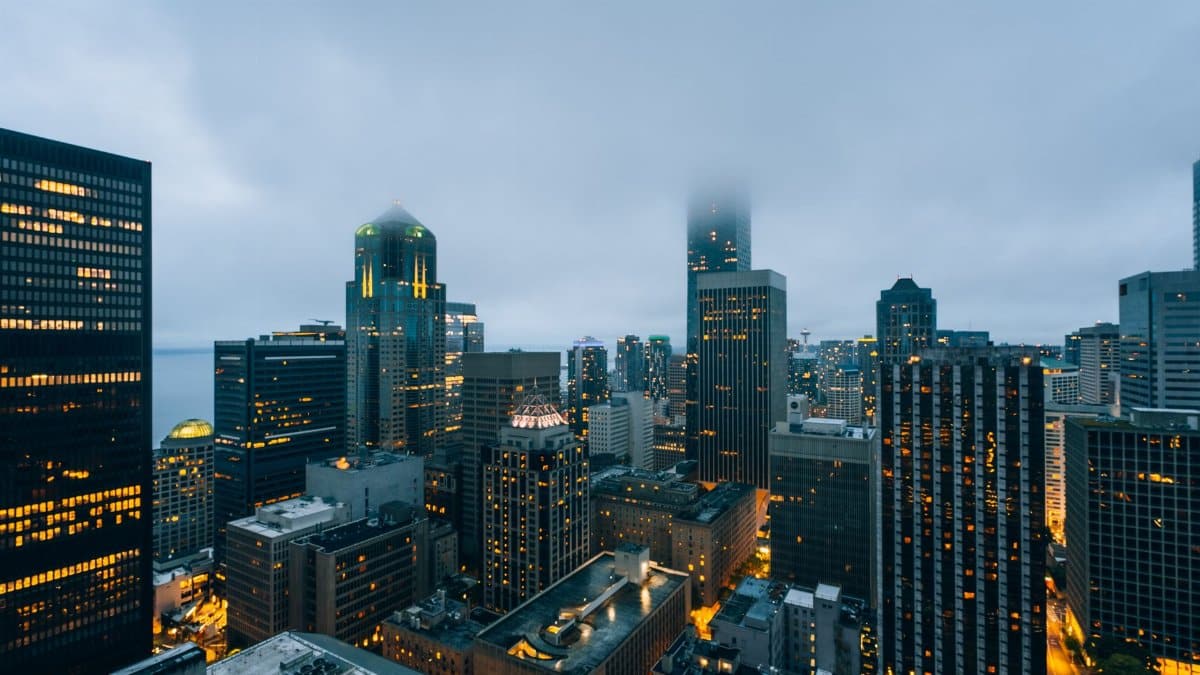 Beautiful view of downtown Seattle skyline with skyscrapers under a cloudy evening sky.