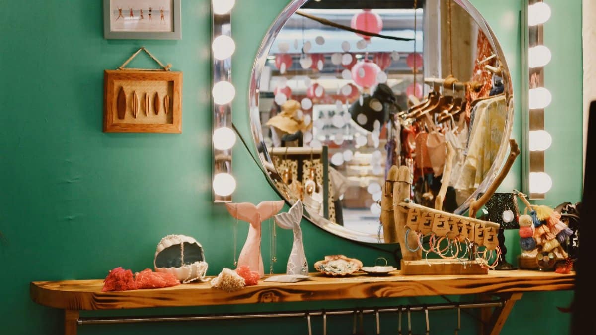 Charming vintage dressing room with round mirror and eclectic decor.
