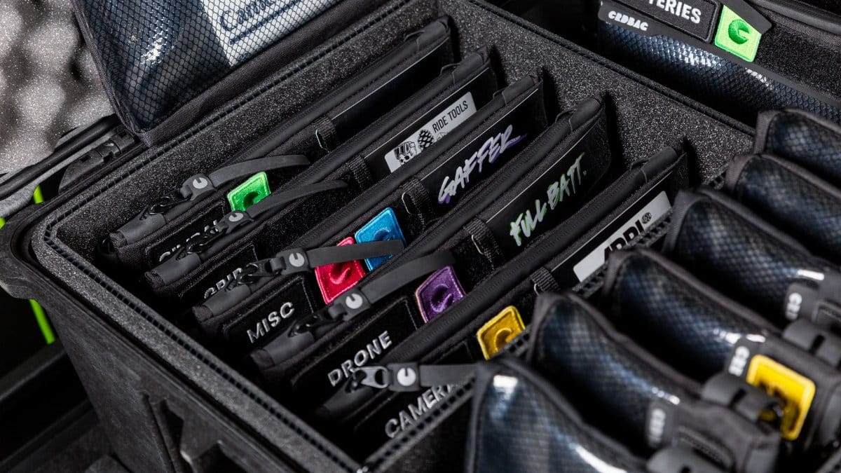 A detailed view of labeled gear compartments in a sturdy protective case, ideal for travel.