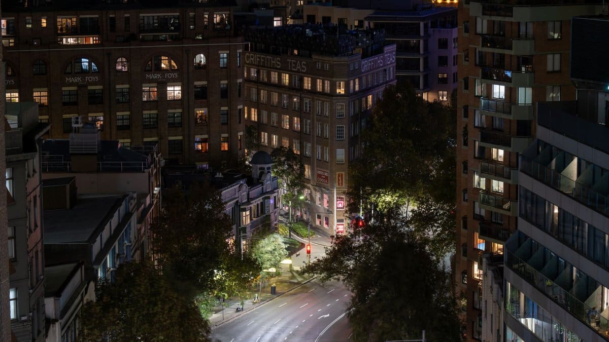 Captured Griffiths Teas Building and city lights illuminating a quiet night in downtown Sydney, Australia.
