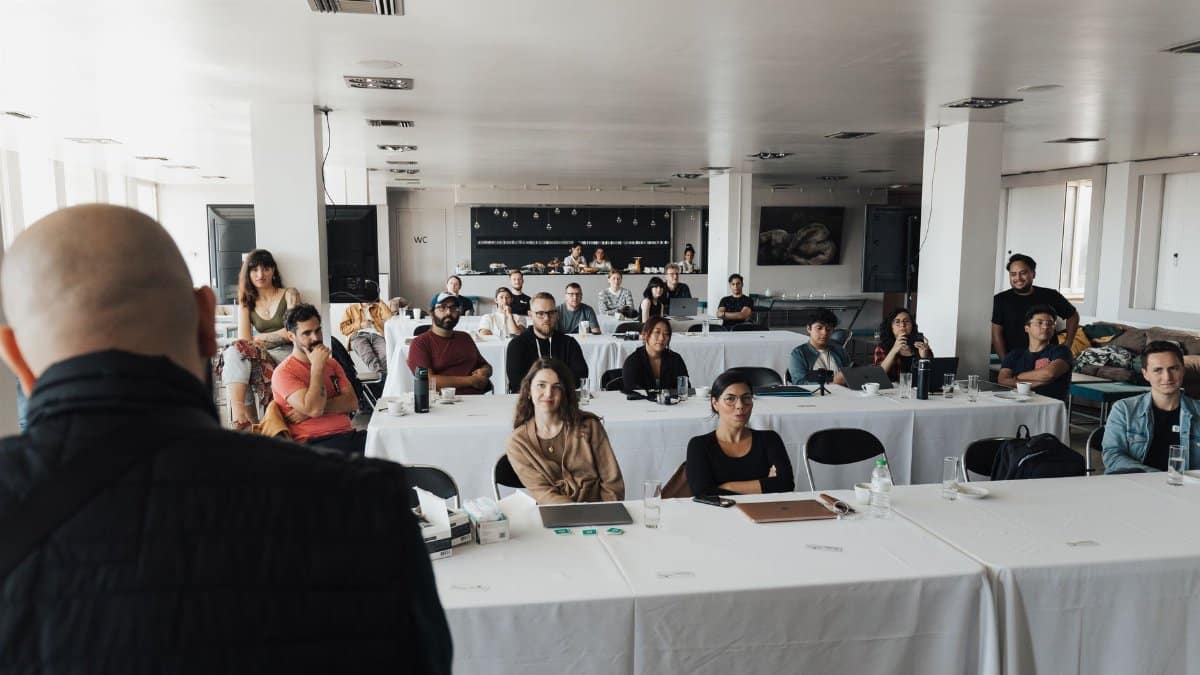 A diverse group of business professionals attending a presentation in a modern conference room.