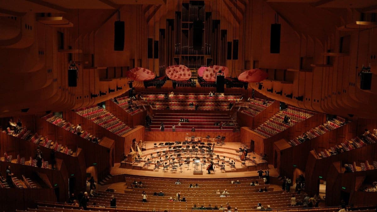 A wide-angle view of the iconic Sydney Opera House concert hall with audience seating.