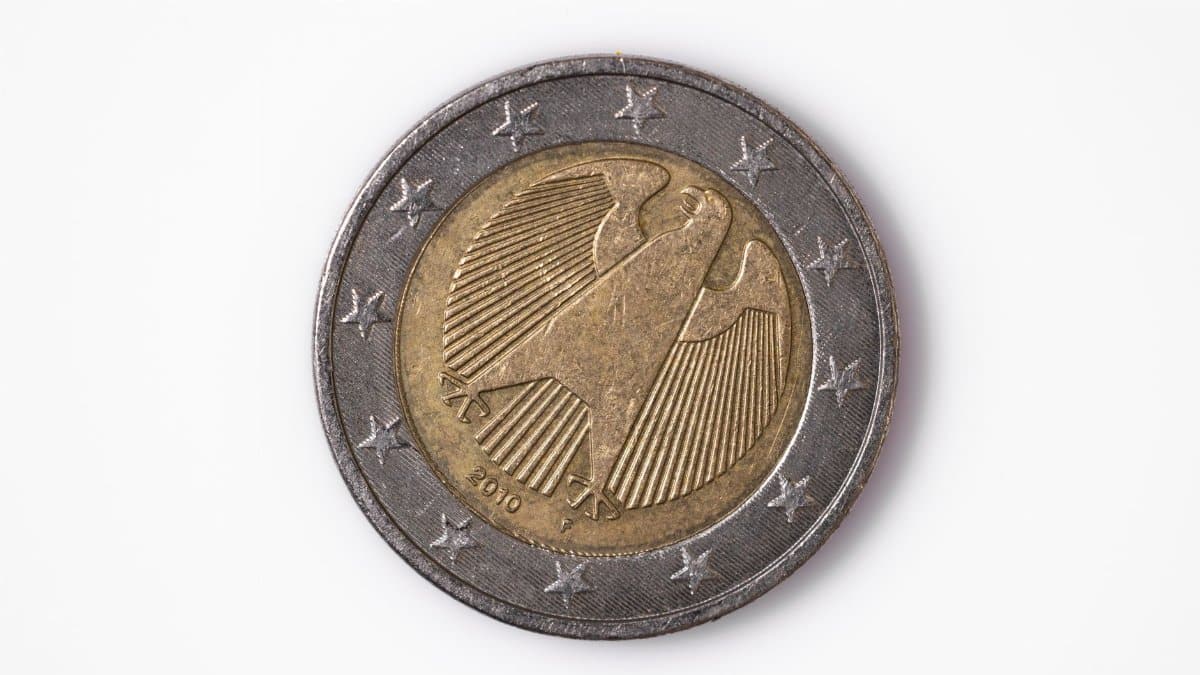 Macro photo of a 2 euro coin featuring a detailed design with stars on a white background.