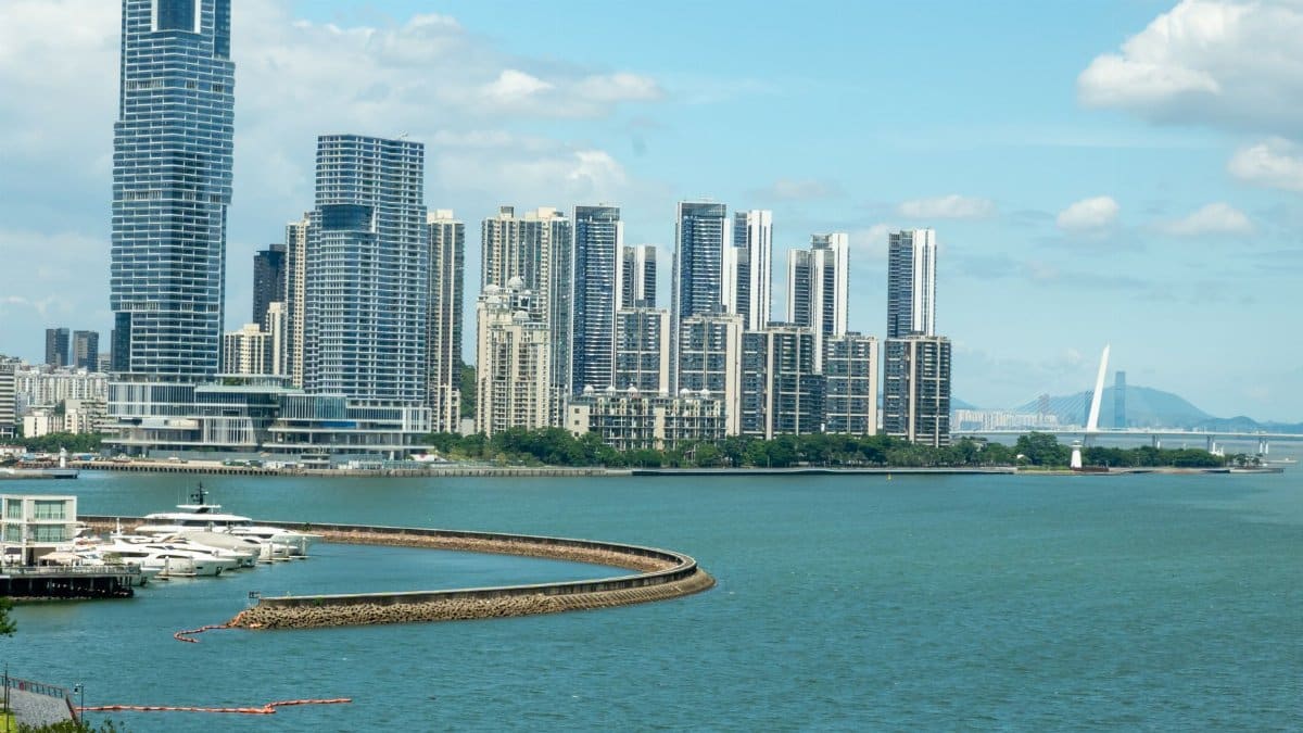 Captivating view of Shenzhen skyline with towering skyscrapers along the waterfront under a bright blue sky.