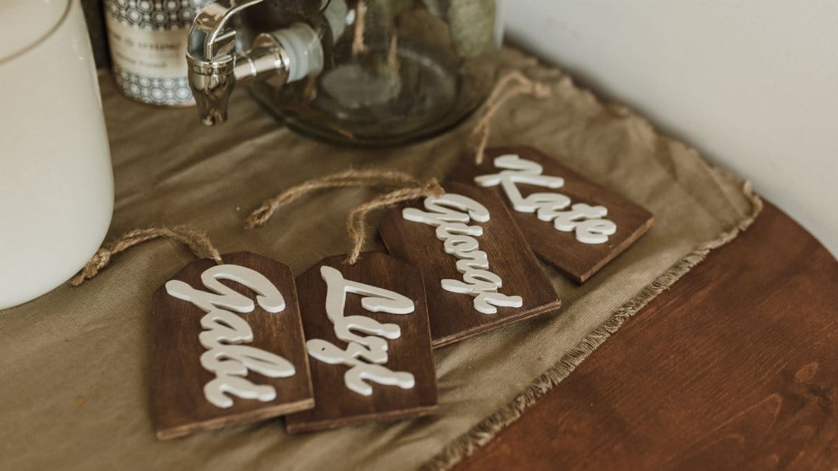 Charming wooden name tags with elegant script on a rustic tabletop setting.