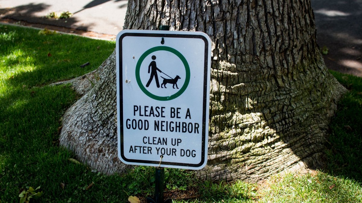Sign in Beverly Hills park urging dog owners to clean up after their pets.