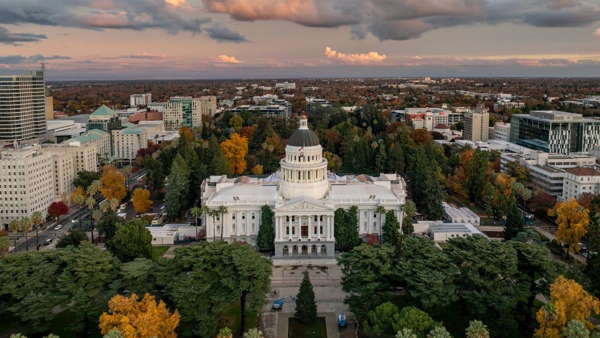 Aerial image of the California State Capitol surrounded by colorful fall foliage in Sacramento.