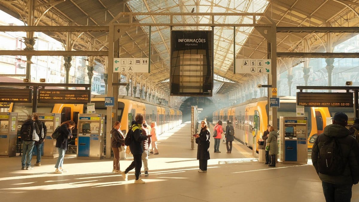 Commuters in the bright interior of São Bento Train Station, Porto, Portugal.