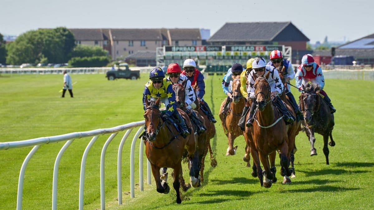 Dynamic view of a thrilling horse race with jockeys in action at Musselburgh Racecourse.
