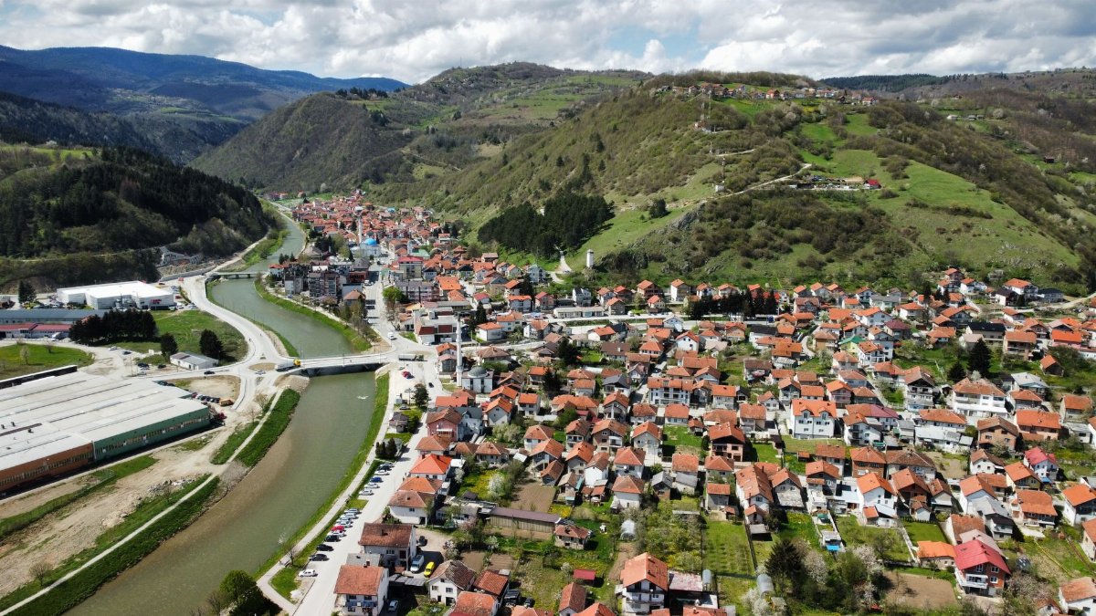 Picturesque aerial view of Donji Vakuf showcasing river, hills, and town layout.