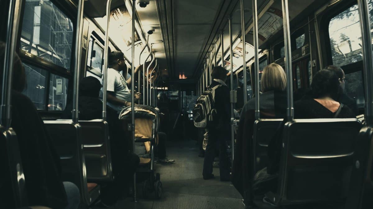 Passengers riding a city bus at night, showcasing urban commute and public transport.