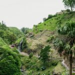 A picturesque landscape featuring a waterfall in the verdant hills of the Azores, Portugal.