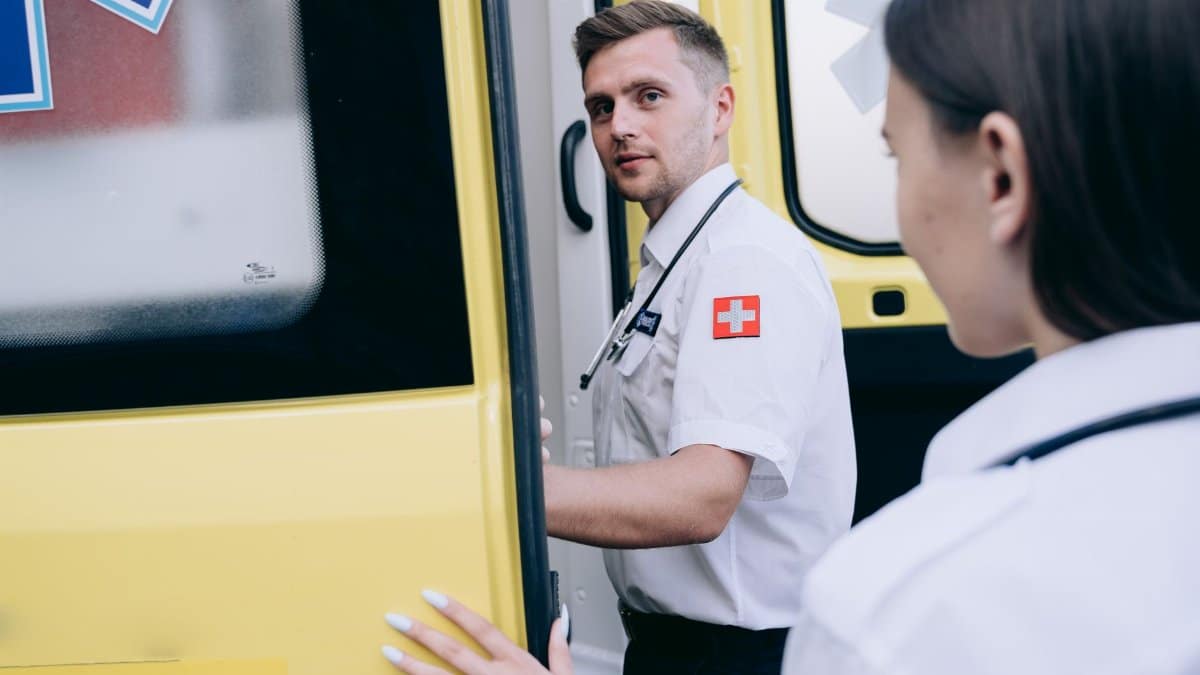 Paramedics entering ambulance ready for emergency response, showcasing teamwork and healthcare professionalism.