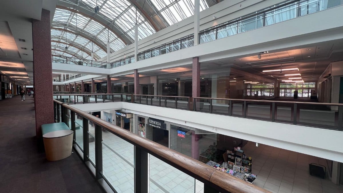 Spacious indoor shopping mall with a skylight roof in Portland, Oregon, showcasing modern architecture.