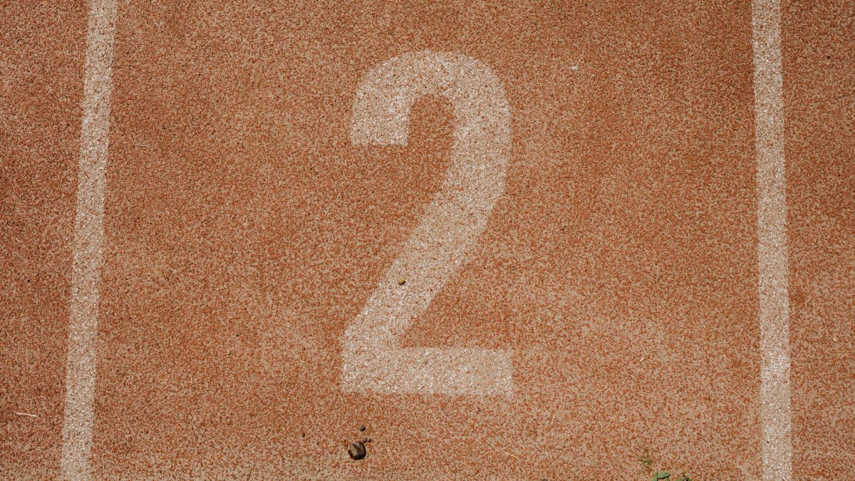 Close-up of number two on a track starting line, perfect for sports themes.