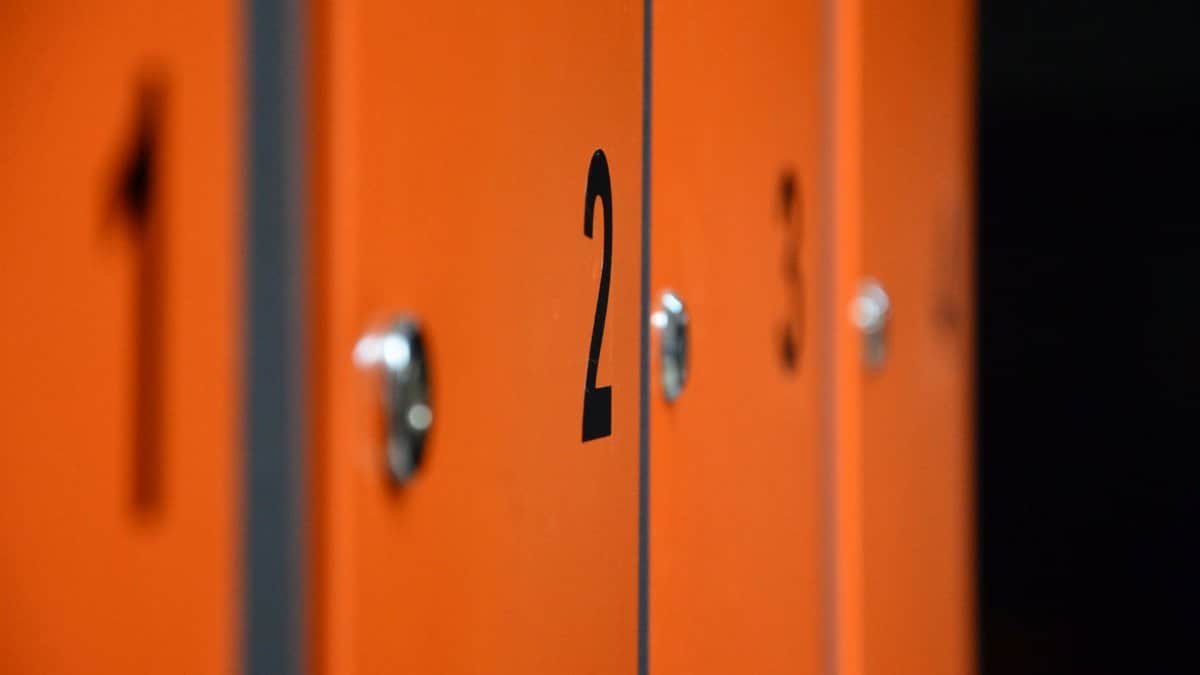 Close-up of orange lockers with numbers, focusing on locker number two.