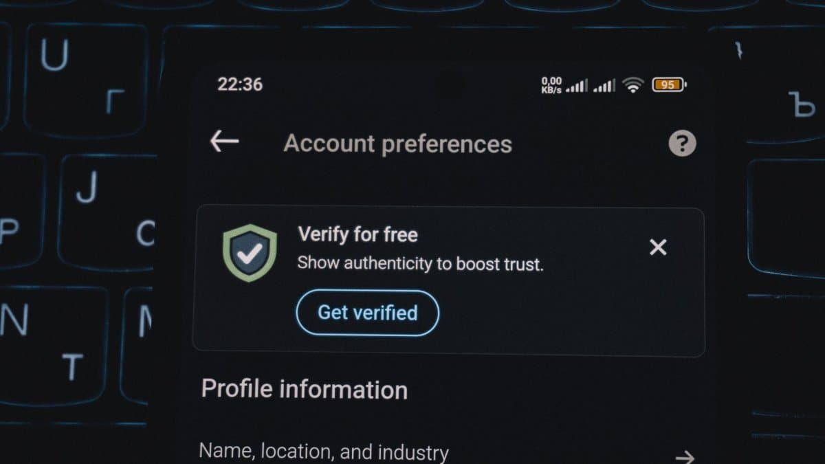 Close-up of a smartphone screen displaying account verification alert. Ideal for security and authenticity themes.