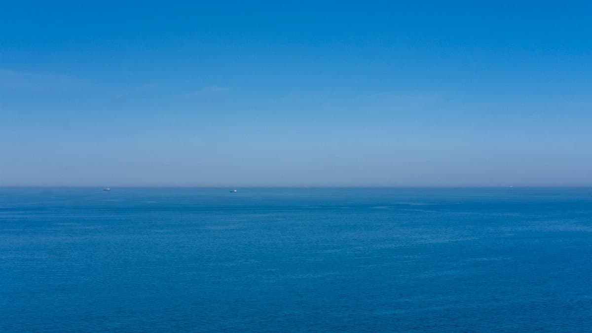 A serene view of the expansive ocean meeting the sky, showcasing tranquility and open space.