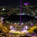 A stunning aerial view of the illuminated Golden 1 Center in downtown Sacramento at night.