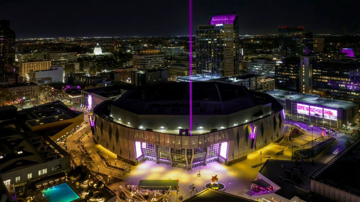 A stunning aerial view of the illuminated Golden 1 Center in downtown Sacramento at night.
