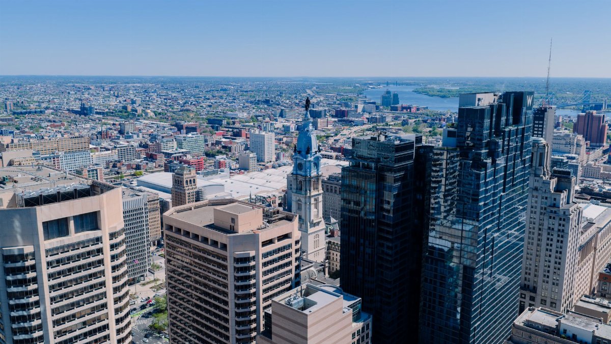 An aerial view of Philadelphia's skyline featuring the iconic City Hall on a clear day.