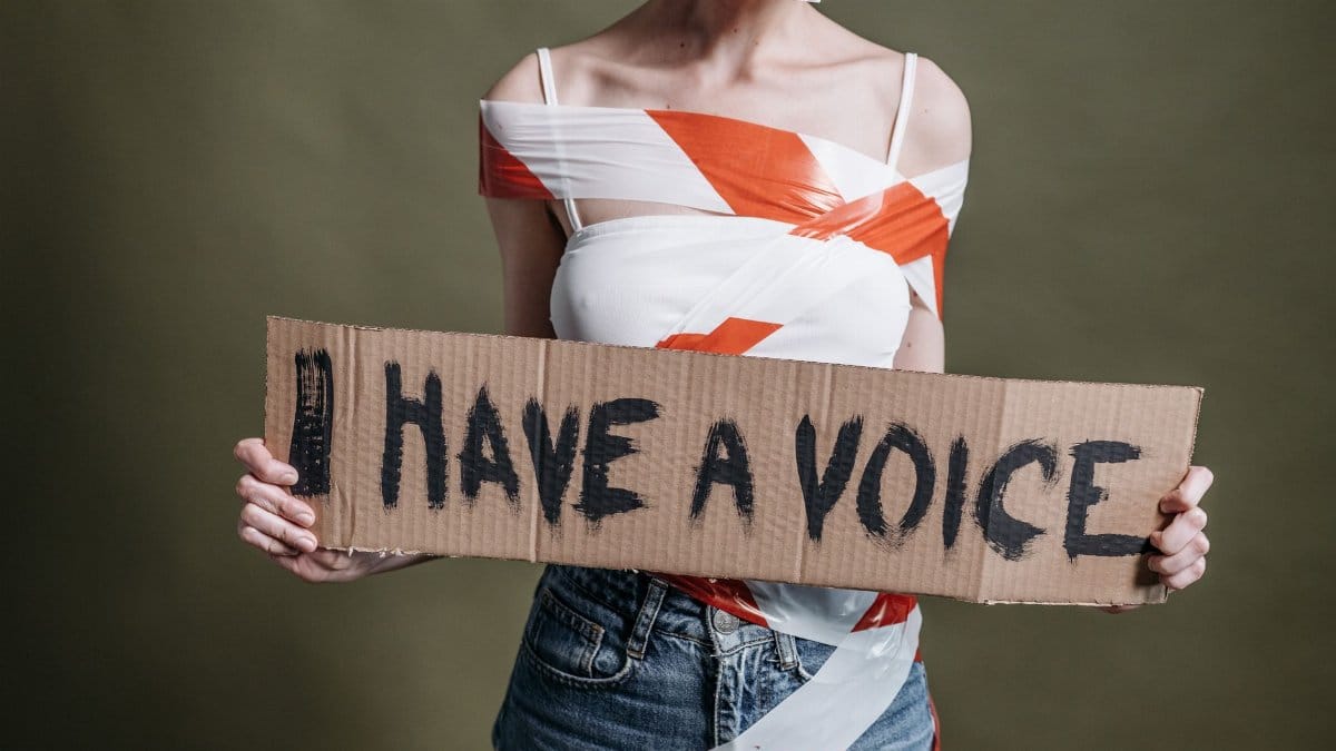 A protest scene emphasizing human rights and empowerment with a bold 'I Have a Voice' sign.