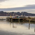 A tranquil view of the dock at Tokeland, WA, under cloudy skies with calm waters.