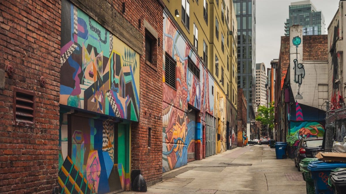 A colorful graffiti-covered alley in downtown Seattle showcasing urban street art.
