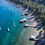 Stunning aerial shot of Lake Tahoe's forested shoreline and boats during summer.