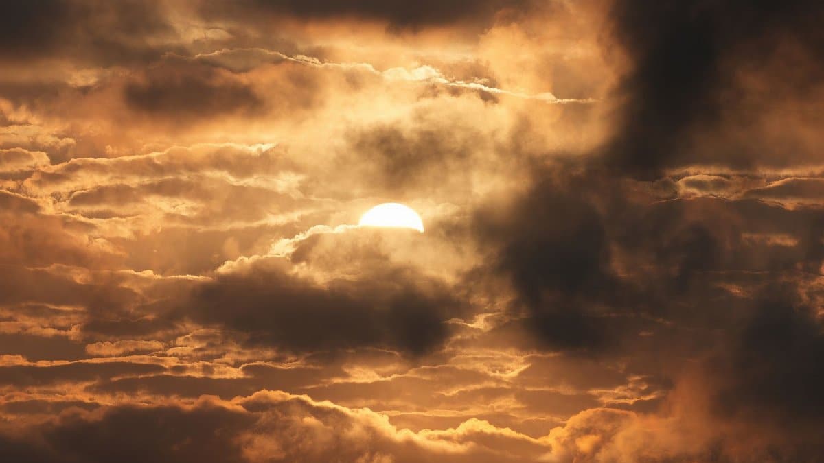 Beautiful sunrise behind clouds in Stamford, Connecticut, creating a dramatic effect with warm tones.