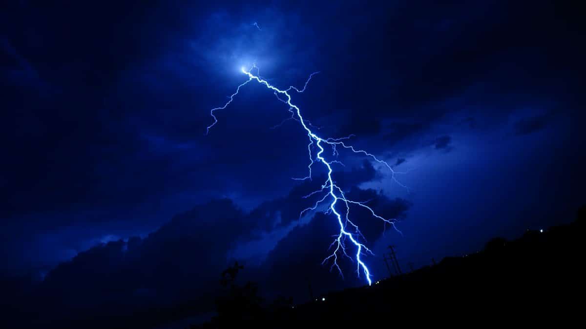 A powerful lightning bolt illuminating a dark nighttime sky in Georgetown, Texas.